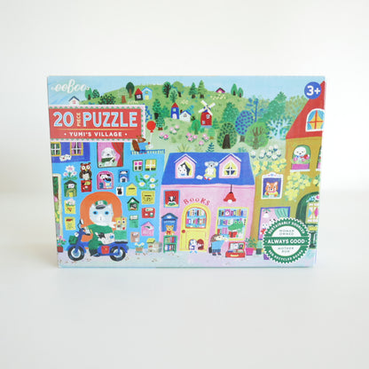 Children's puzzle box with a colorful village scene on a white background